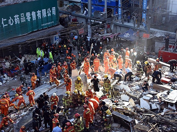 Equipe de resgate busca sobreviventes entre destroços após o desabamento de quatro prédios em Wenzhou. Foto: FP/Stringer